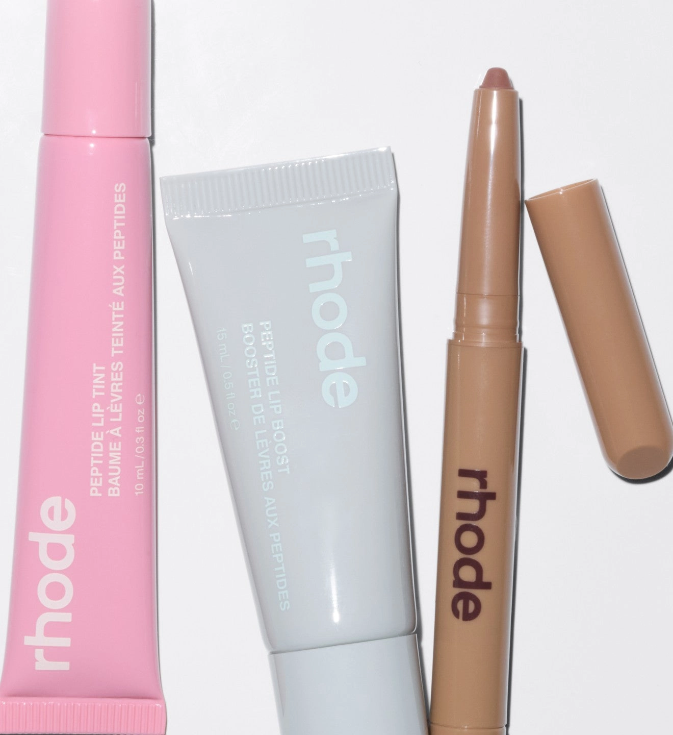 pink and grey rhode tubes beside a bronze stick